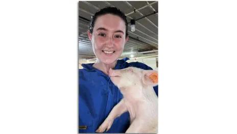 Katherine Mastey with piglet